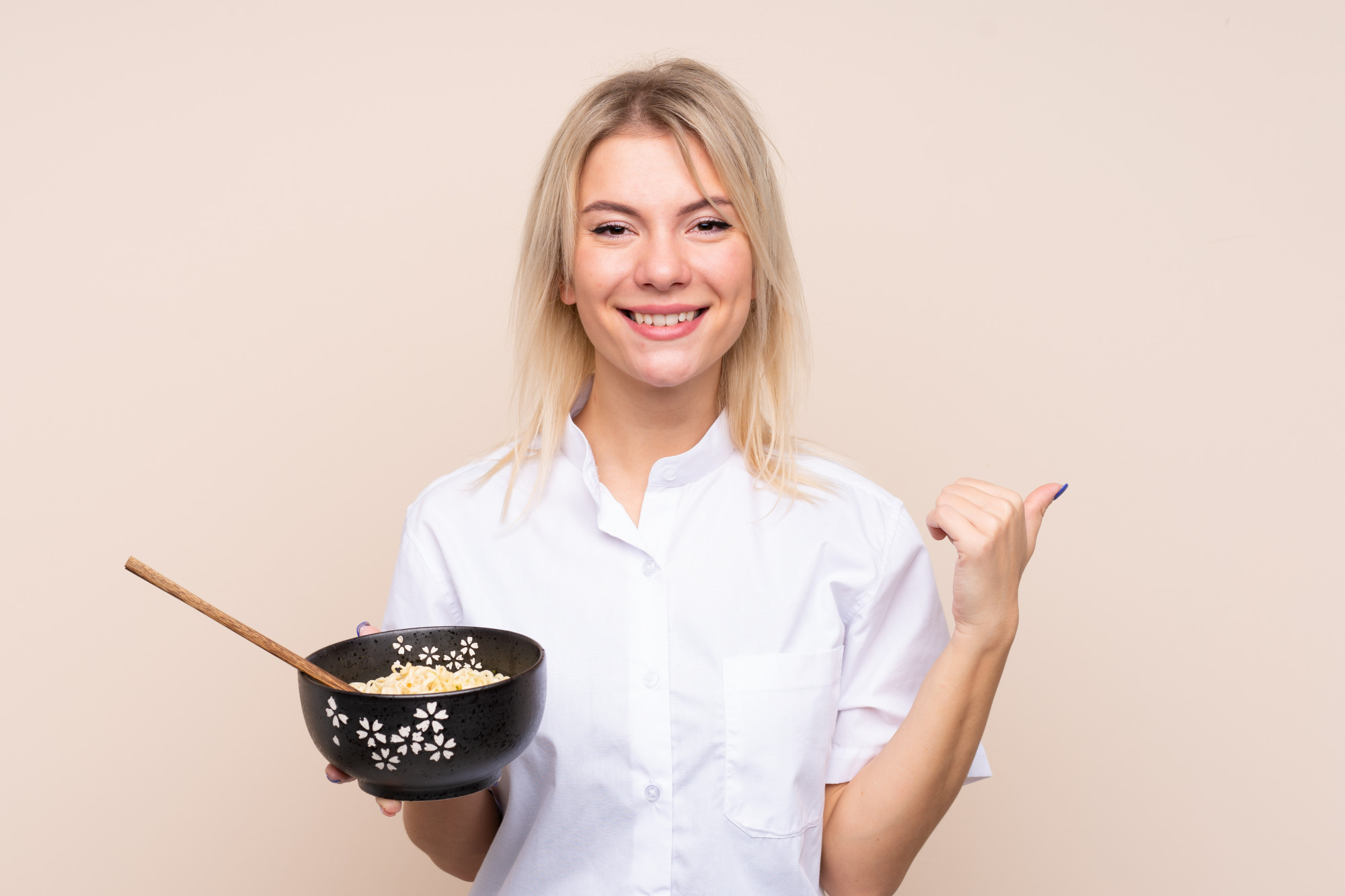 Instructor smiling with prepared dishes in workshop